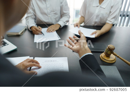 Lawyer and justice concept, Senior lawyer provides advice to couple about their divorce agreement 92687005