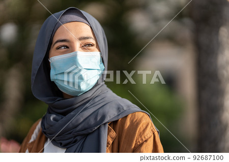 Muslim woman wearing protective facial mask outdoors Muslim woman wearing protective facial mask outdoors 92687100