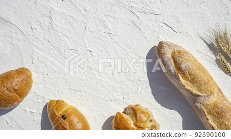 Baguette and wheat on white background 92690100