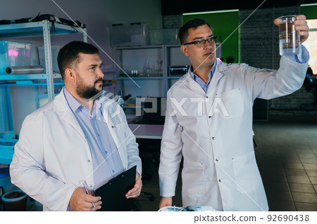 Two male laboratory assistants are doing research on chemicals 92690438