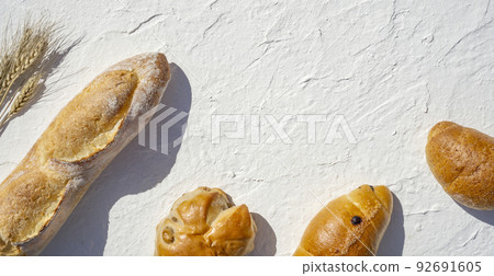 Baguette and wheat on white background 92691605