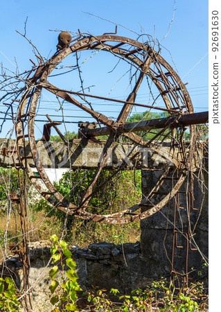An old abandoned well with a scary doll head on it 92691630