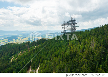 Sky walk observation tower in the forest between mountain hills near Sky Bridge 721 in a sunny summer day, Dolni Morava, Czech Republic. Sky walk observation tower in the forest between mountain hills near Sky Bridge 721 in a sunny summer day, Dolni Morava, Czech Republic. 92692105