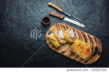 Wellington pork, pork tenderloin baked with mushrooms in puff pastry. 92692198
