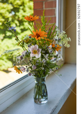 Beautiful bouquet of wildflowers isolated on windowsill. Beautiful bouquet of wildflowers isolated on windowsill. 92692797