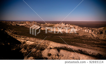 Panorama view to Aral sea from the rim of Plateau Ustyurt at sunset , Karakalpakstan, Uzbekistan Panorama view to Aral sea from the rim of Plateau Ustyurt at sunset , Karakalpakstan, Uzbekistan 92693114