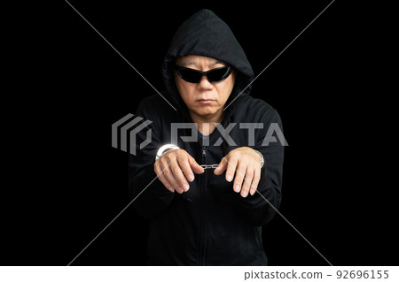 man in sunglasses handcuffed 92696155
