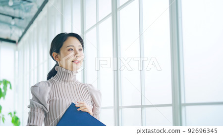 Woman walking in modern office 92696345