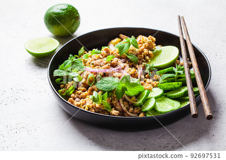 Thai chicken salad larb gai with onion, cucumber and mint. Asian food concept. 92697531