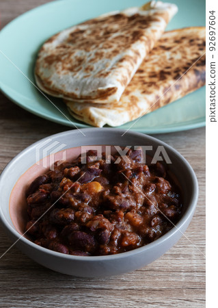 Chili con carne in a bowl with quesadillas Chili con carne in a bowl with quesadillas 92697604