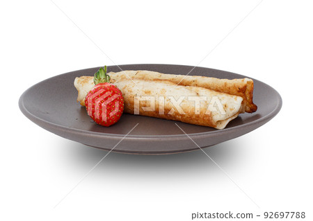 Homemade pancakes filled with cottage cheese on a plate 92697788