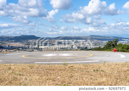 Helipad. Helicopter Landing Pad near emergency hospital in Portugal with cloud sky and city on background 92697971