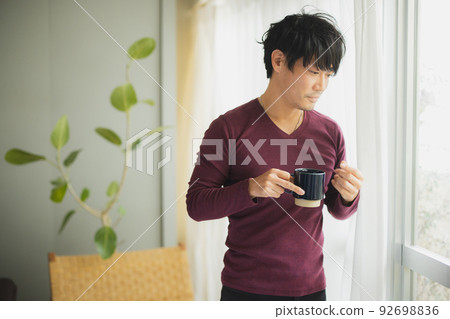 A man by the window A man by the window 92698836