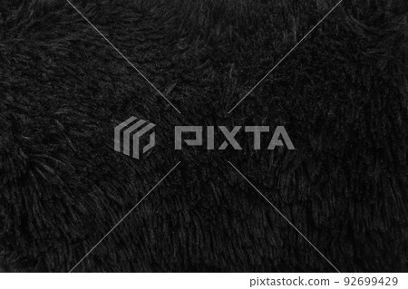 Faux fur black wool abstract pattern nature skin soft warm fluffy background dark artifical texture Faux fur black wool abstract pattern nature skin soft warm fluffy background dark artifical texture 92699429