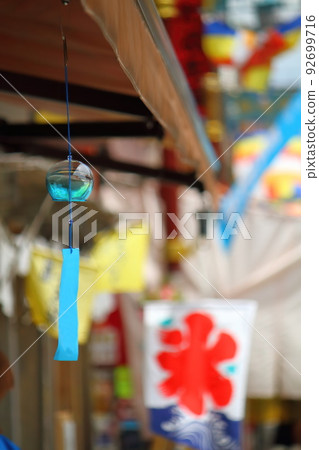 Blue wind chimes and summer cityscape 92699716