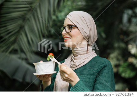 Arab girl eating healthy meal. 92701384