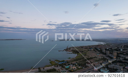 Dark clouds on horizon. Sunset over a small town 92701618