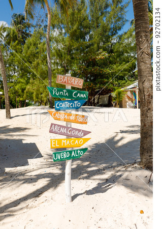 Dominican Republic Bavaro Punta Cana provinces La Altagracia. Wooden pillar with signposts directions 92702134