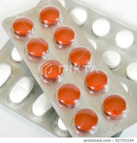 White and orange pills packed and used in healthy environment White and orange pills packed and used in healthy environment 92703184