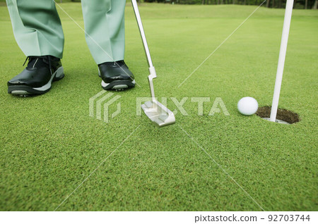 Golfer putting, low section Golfer putting, low section 92703744