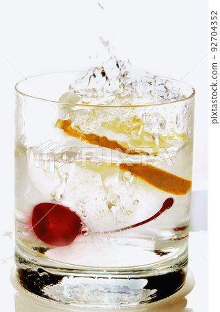Cherry splashing into martini glass Cherry splashing into martini glass 92704352