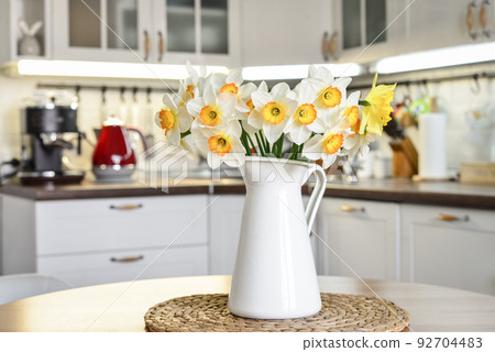 Bouquet of daffodils in interior of the kitchen 92704483