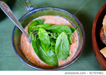 sauce with lettuce leaves in a bowl on the table.  92705962