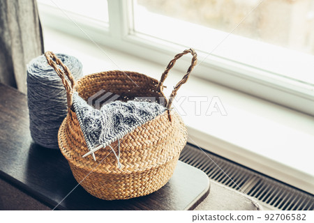 Wicker basket with knitting in progress Wicker basket with knitting in progress 92706582