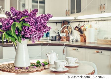 Bouquet of purple Lilac flowers in interior of the kitchen Bouquet of purple Lilac flowers in interior of the kitchen 92706690