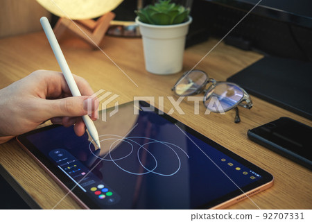 Man using digital tablet for drawing. 92707331
