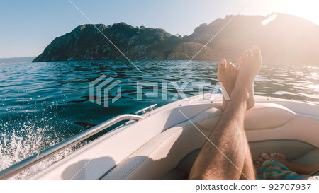 First person view of a man relaxing on a boat 92707937