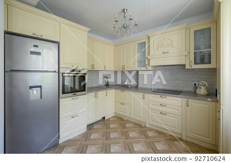 Interior of modern trendy cream colored kitchen Interior of modern trendy cream colored kitchen 92710624