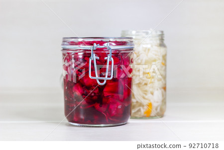 Sauerkraut and red cabbage on a wooden background. Fermented foods. Sauerkraut and red cabbage on a wooden background. Fermented foods. 92710718