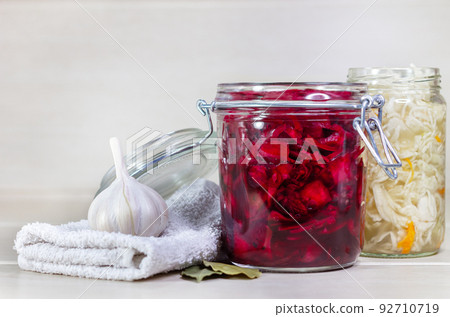 Homemade Sauerkraut with Carrot and Salad Cabbage with Beetroot on a wooden table. Fermented food. 92710719