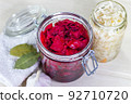 Homemade Sauerkraut with Carrot and Salad Cabbage with Beetroot on a wooden table. Fermented food. 92710720