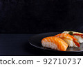 Nigiri sushi set on black background, traditional Japanese food. 92710737