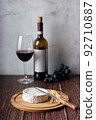 Red wine with cheese plate. Assorted cheeses Camembert and smoke cheese. 92710887