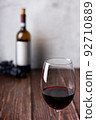 Red wine glasses and bottle on wooden background. 92710889