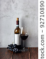 Wine bottles with glass and grape on wooden background. 92710890