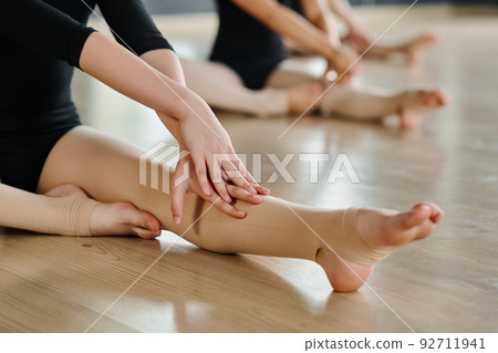 Stretched leg of flexible adolescent girl practicing choreographic exercise Stretched leg of flexible adolescent girl practicing choreographic exercise 92711941