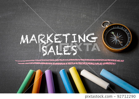 Marketing Sales. Compass and colored pieces of chalk on a blackboard 92712290