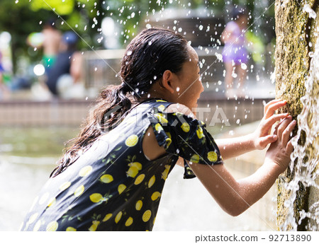 Cute elementary school students playing in the water Cute elementary school students playing in the water 92713890