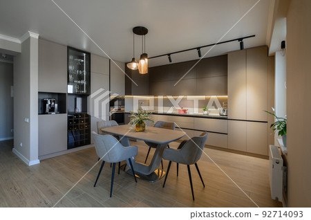 Large modern grey luxurious kitchen and dining room in studio apartment Large modern grey luxurious kitchen and dining room in studio apartment 92714093