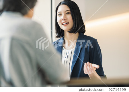 A woman explaining to a customer 92714399