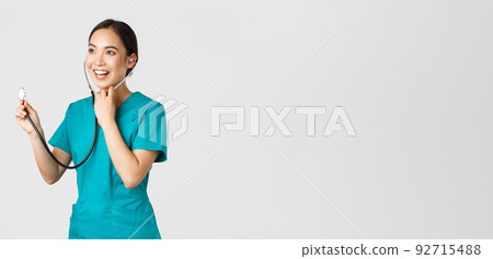 Covid-19, healthcare workers and preventing virus concept. Smiling friendly-looking asian female doctor listening to patient lungs during daily checkup, using stethoscope, white background Covid-19, healthcare workers and preventing virus concept. Smiling friendly-looking asian female doctor listening to patient lungs during daily checkup, using stethoscope, white background 92715488