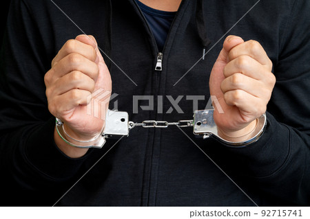 close up of handcuffed arms close up of handcuffed arms 92715741