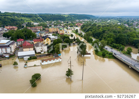 Aerial view of flooded houses with dirty water of Dnister river in Halych town, western Ukraine. 92716267