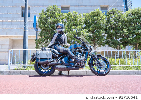 Smiling female rider touring Yokohama 92716641
