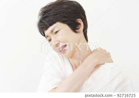 Senior woman with stiff shoulders white background Senior woman with stiff shoulders white background 92716725