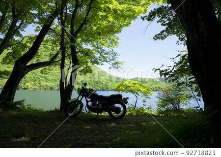 Motorcycles parked on the shore of a lake Motorcycles parked on the shore of a lake 92718821